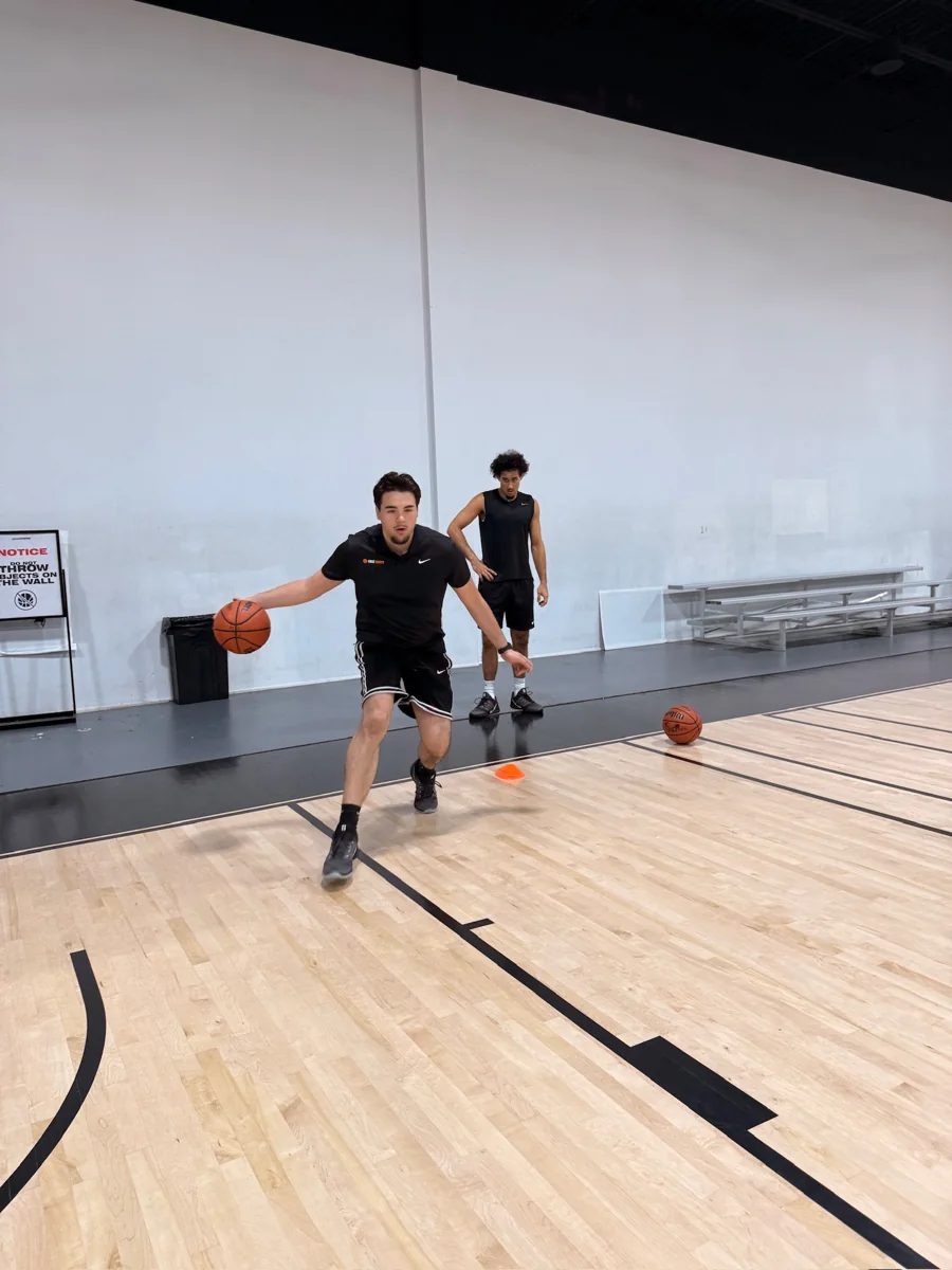 Mert Uraz demonstrating basketball movement during indoor training