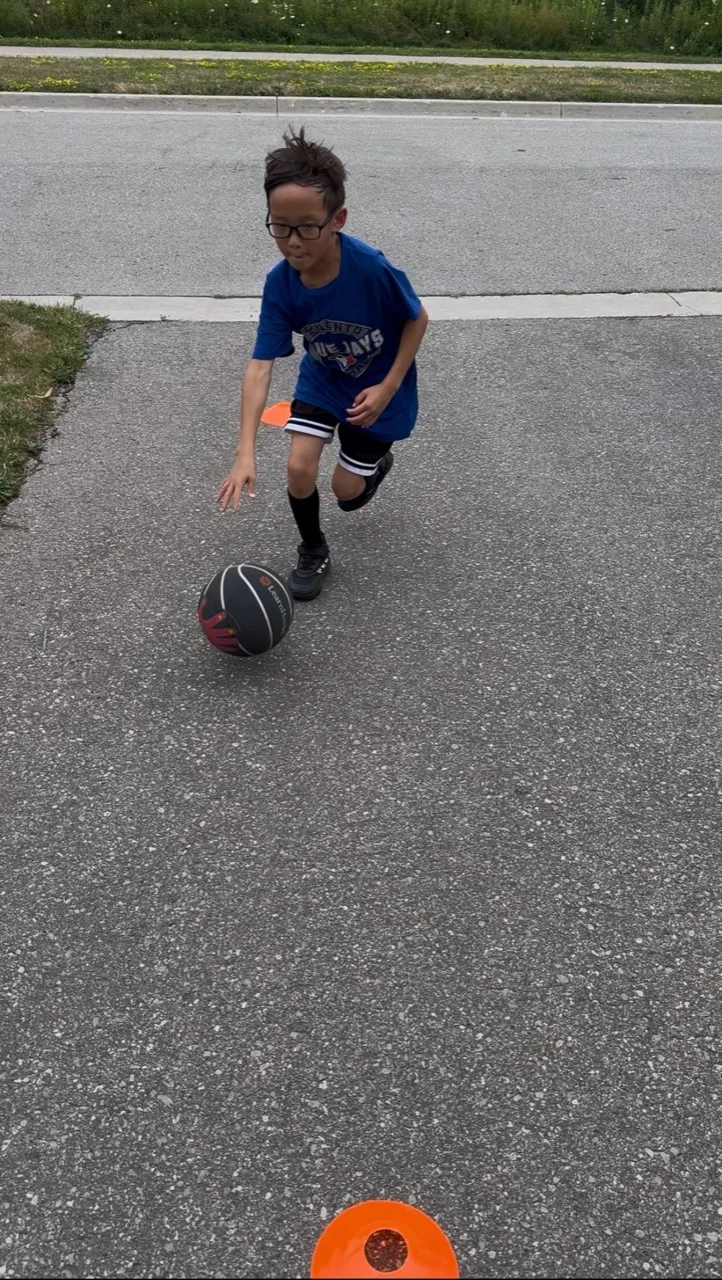 A young player practising dribbling outdoors